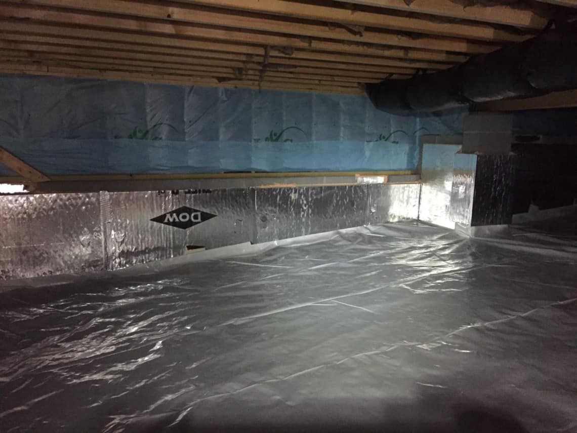 Completed crawl space encapsulation showing sealed liner, wall insulation and sealed terminations in a North Carolina home
