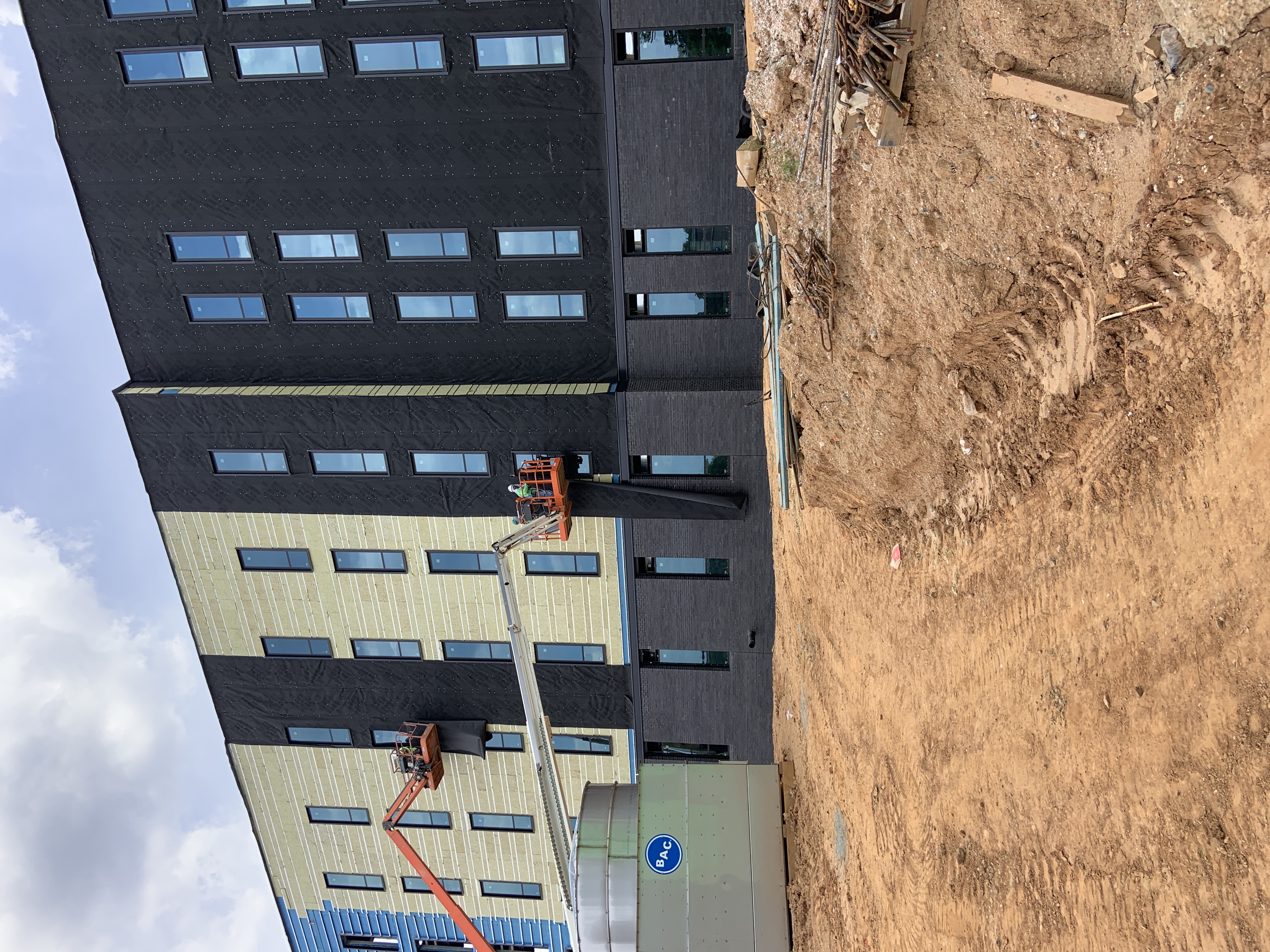 Live Green Inc crew installing a commercial air barrier on a North Carolina building