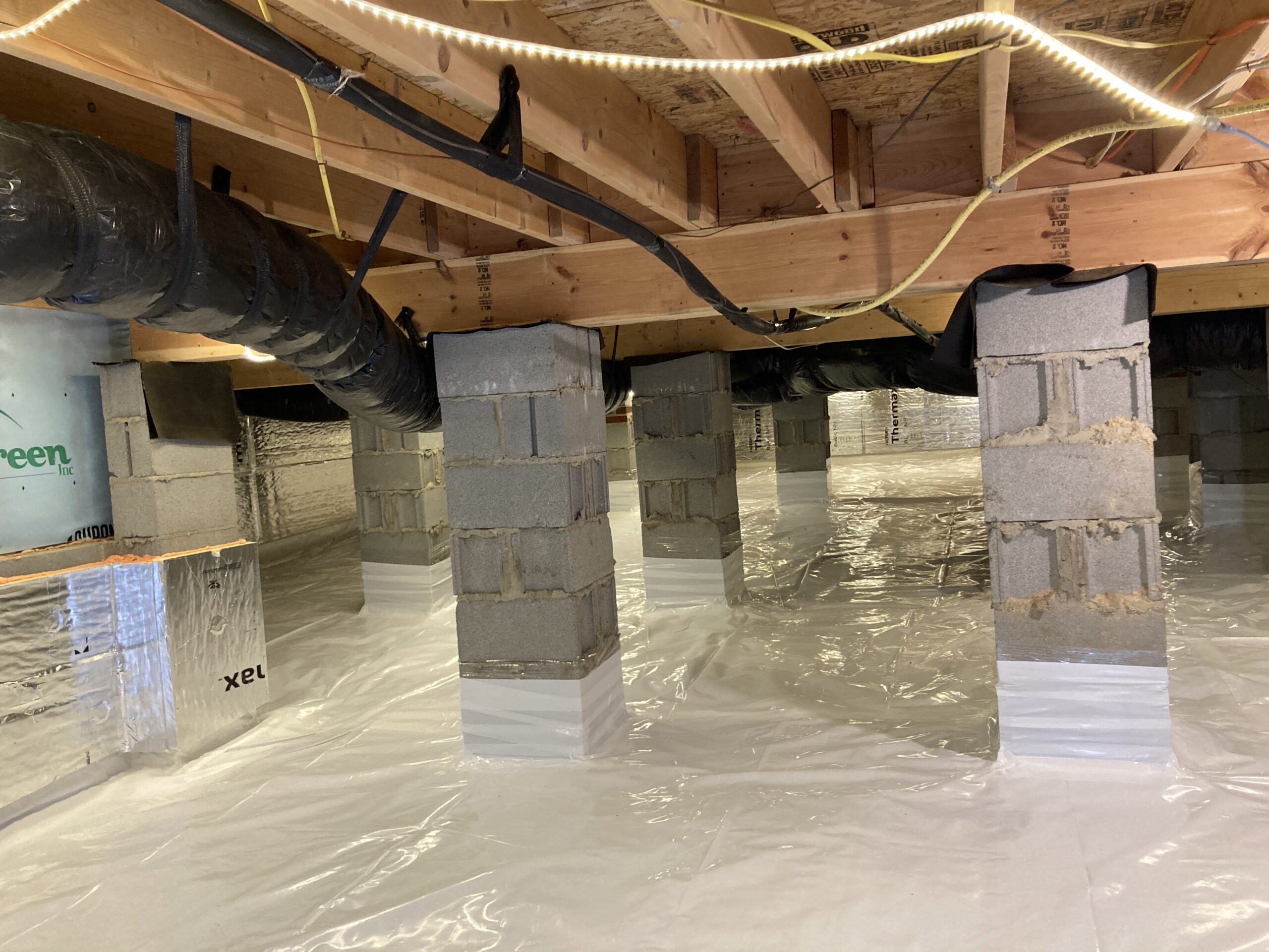 Professionally encapsulated crawl space with white vapor barrier liner